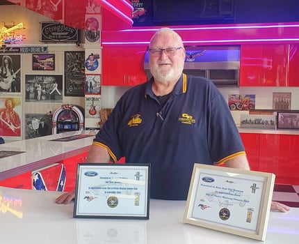 Nelson accepts a certificate for hosting the Mustang club at Ross Bros Museum